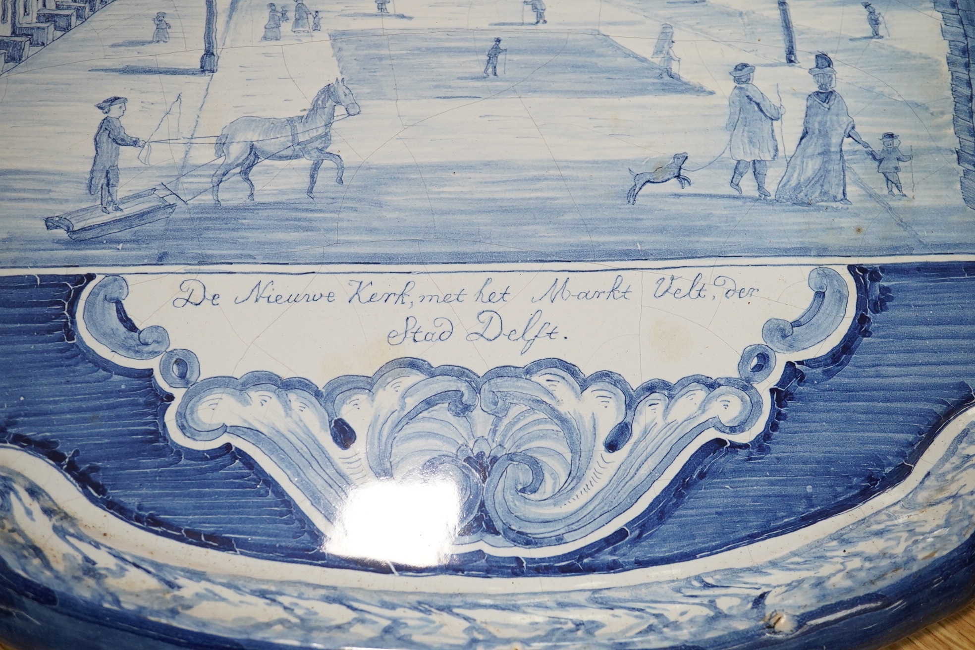 A 19th century Dutch delt shaped oval plaque, 53cm wide. Condition - fair to good